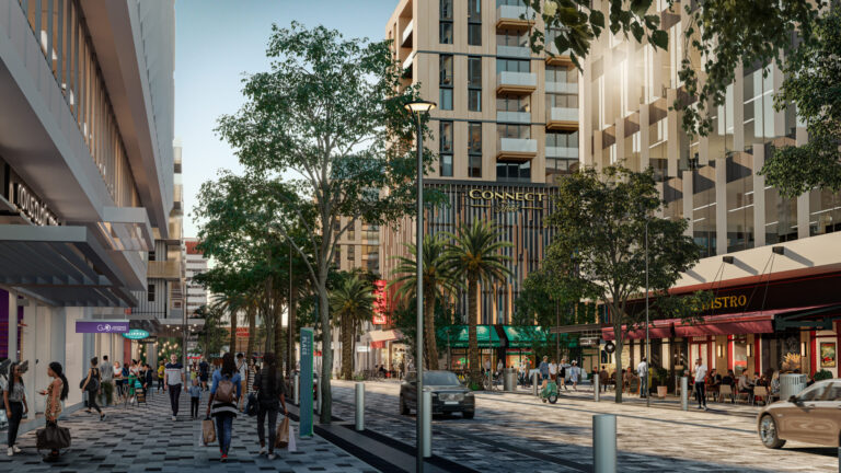 Street level view of Novus Place in Tempe shows people walking with buildings and shops on either side